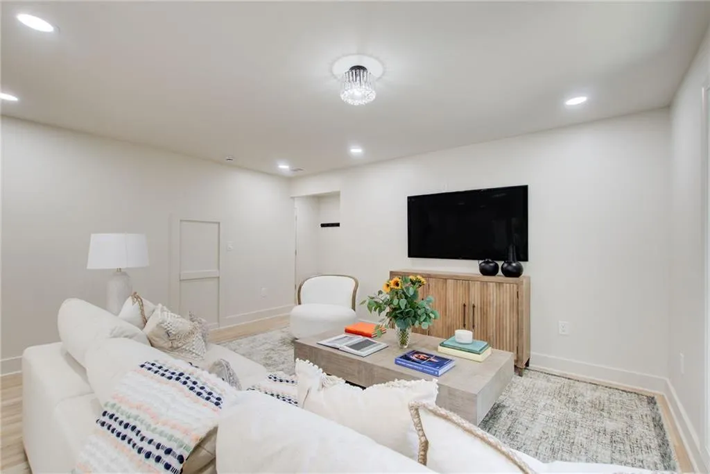 Living room with recessed lighting and light wood-style floors