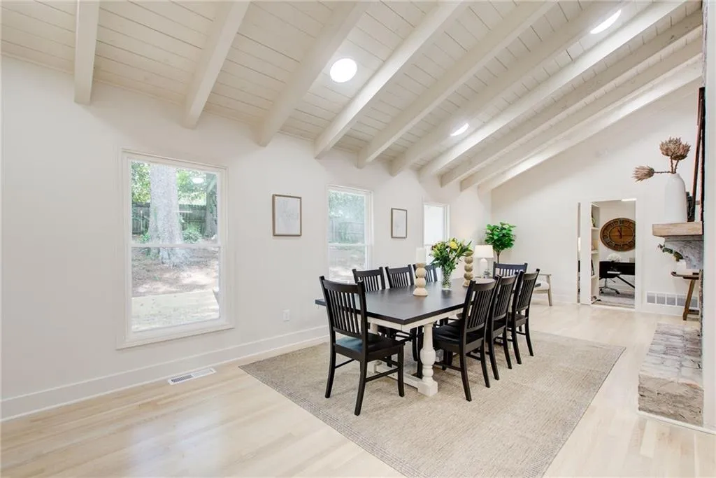 Dining room with light wood-style flooring and wood ceiling