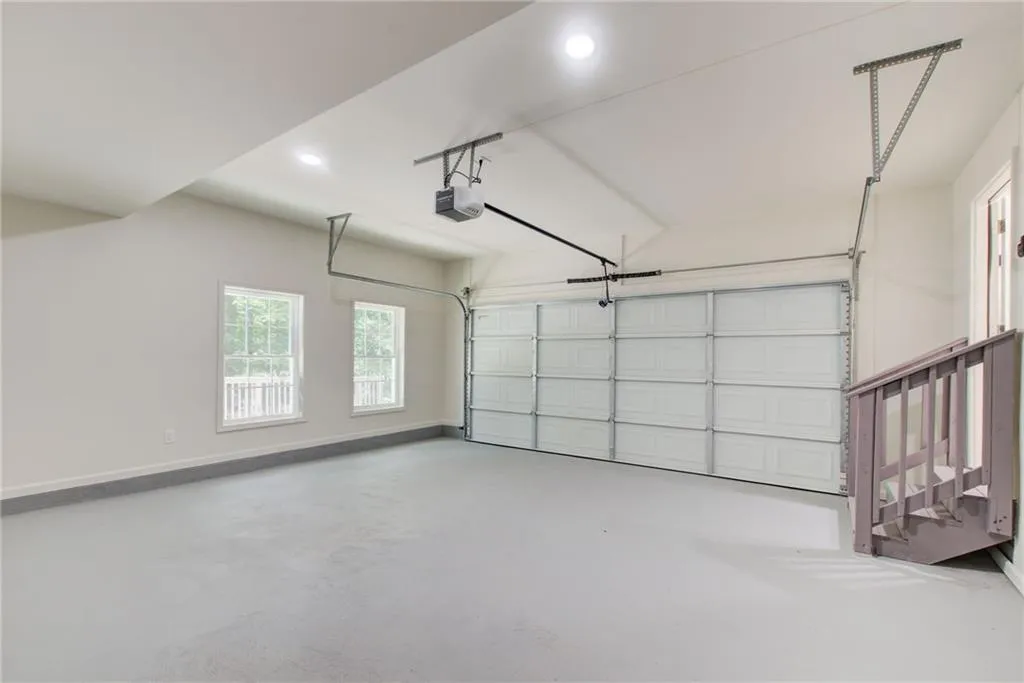Garage with recessed lighting and a garage door opener