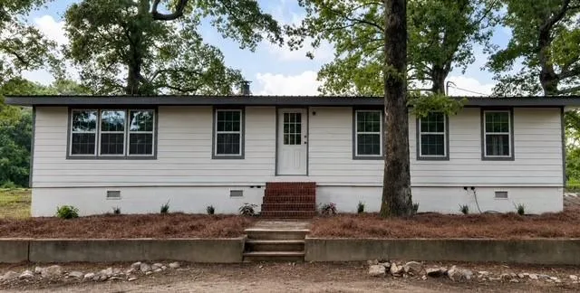 White siding exterior with dark trim windows