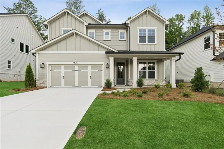 Contemporary two-story residence with a two-car garage, covered entry porch, and mixed siding exterior
