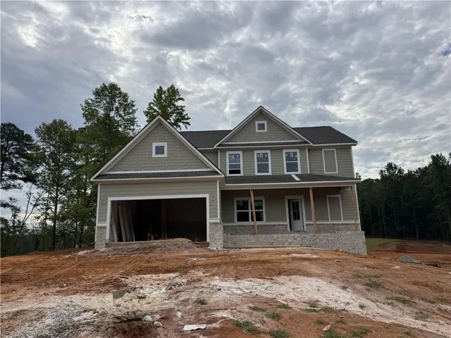 Two-story residence featuring light green siding and a dark shingle roof