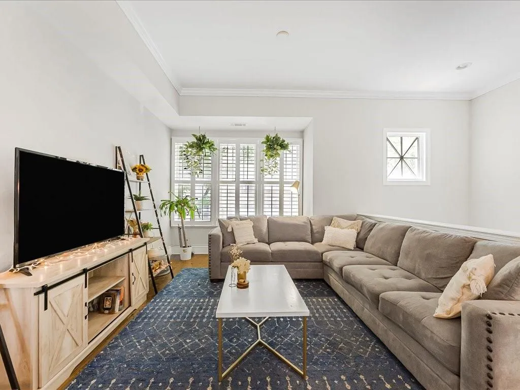 Living room featuring crown molding and wood finished floors