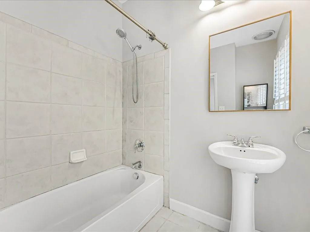Full bath featuring shower / bath combination and tile patterned floors