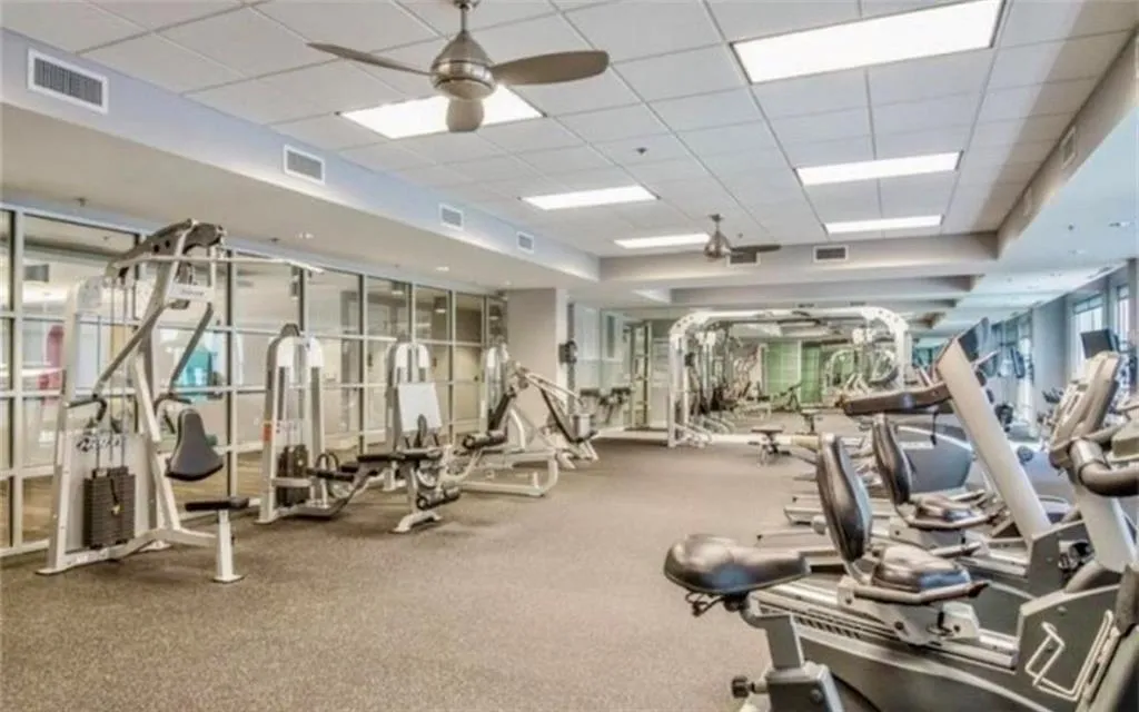 Workout area featuring a paneled ceiling and ceiling fan