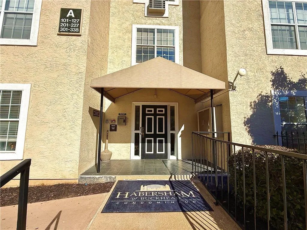 Entrance to property with stucco siding
