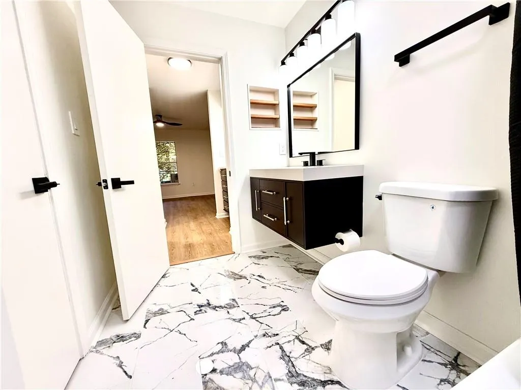Bathroom with vanity and light marble finish floors