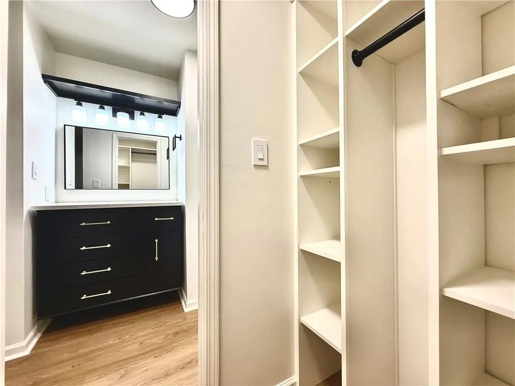 Walk in closet featuring light wood-style floors