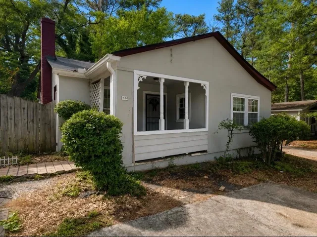 Single-story residence featuring a covered front porch with decorative trim