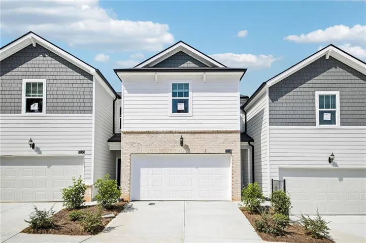 Modern facade featuring gray shake siding and white horizontal siding