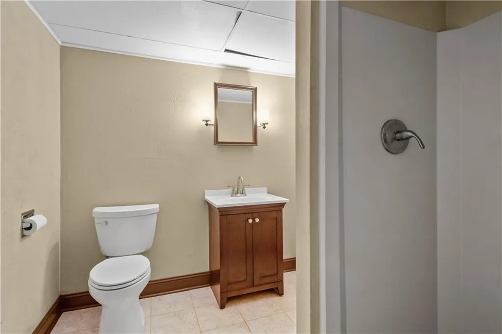 Bathroom featuring tile patterned floors, toilet, and vanity Bathroom featuring tile patterned floors, toilet, and vanity