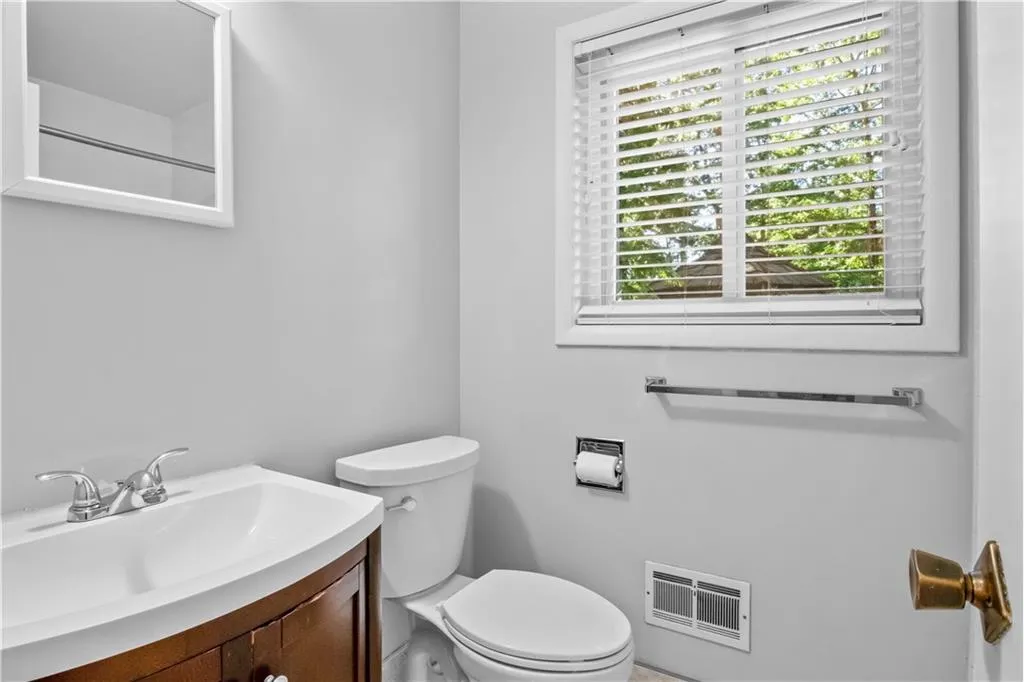 Bathroom featuring vanity and toilet Bathroom featuring vanity and toilet