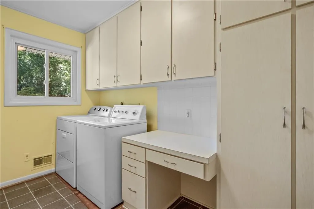 Laundry area featuring washer and dryer and cabinets Laundry area featuring washer and dryer and cabinets