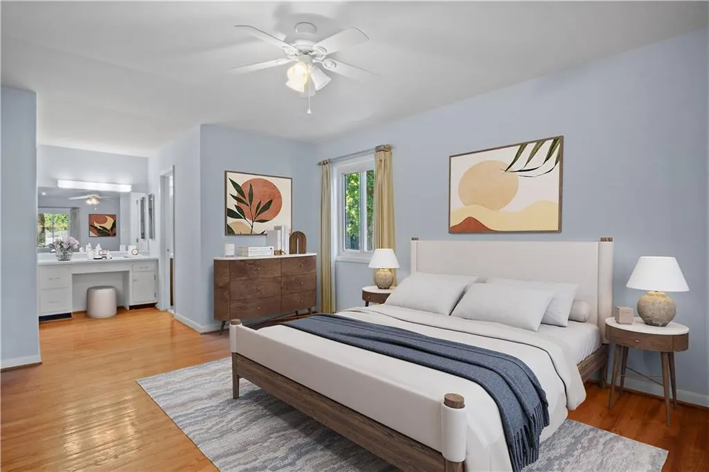 Bedroom with hardwood / wood-style flooring, ensuite bath, ceiling fan, and built in desk Bedroom with hardwood / wood-style flooring, ensuite bath, ceiling fan, and built in desk