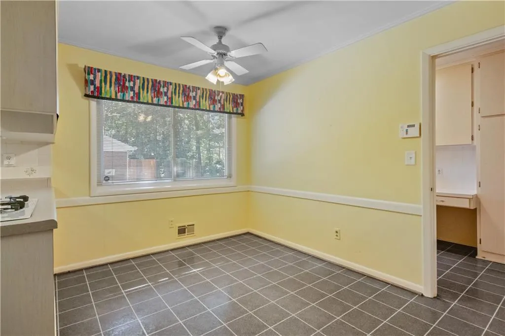 Unfurnished dining area featuring crown molding and ceiling fan Unfurnished dining area featuring crown molding and ceiling fan