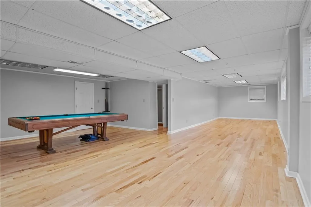 Rec room featuring light wood-type flooring, pool table, and a paneled ceiling Rec room featuring light wood-type flooring, pool table, and a paneled ceiling