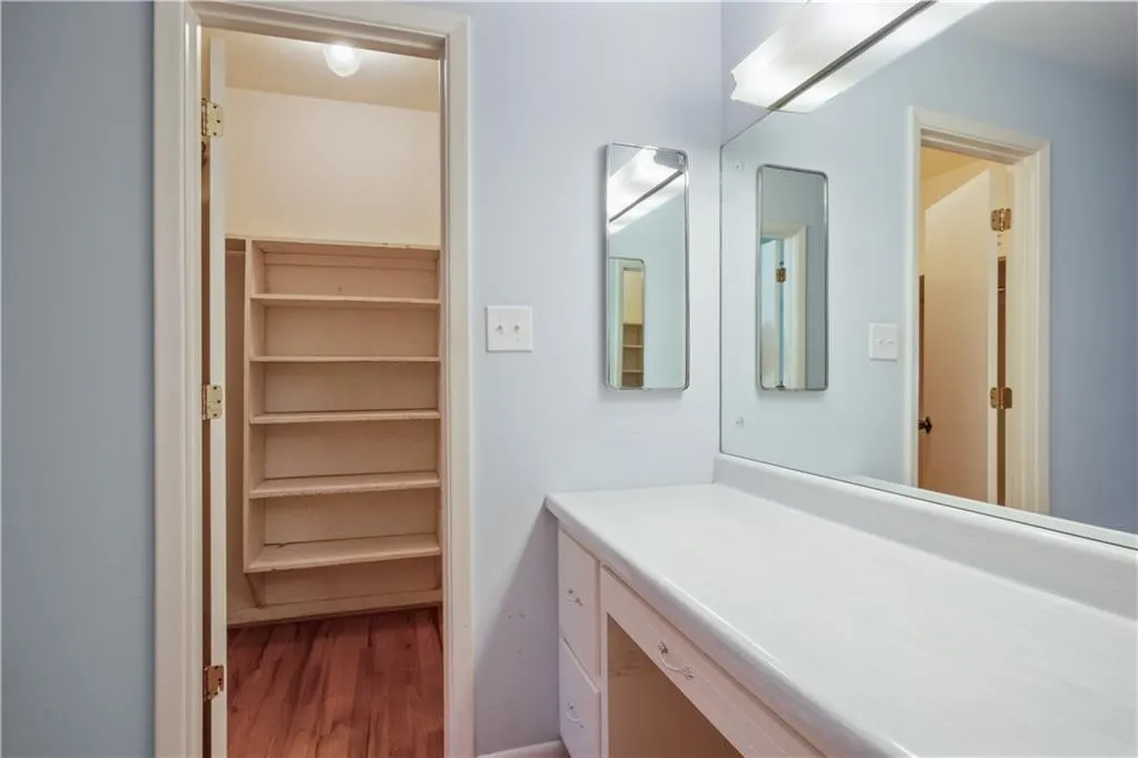 Bathroom featuring vanity and hardwood / wood-style flooring Bathroom featuring vanity and hardwood / wood-style flooring