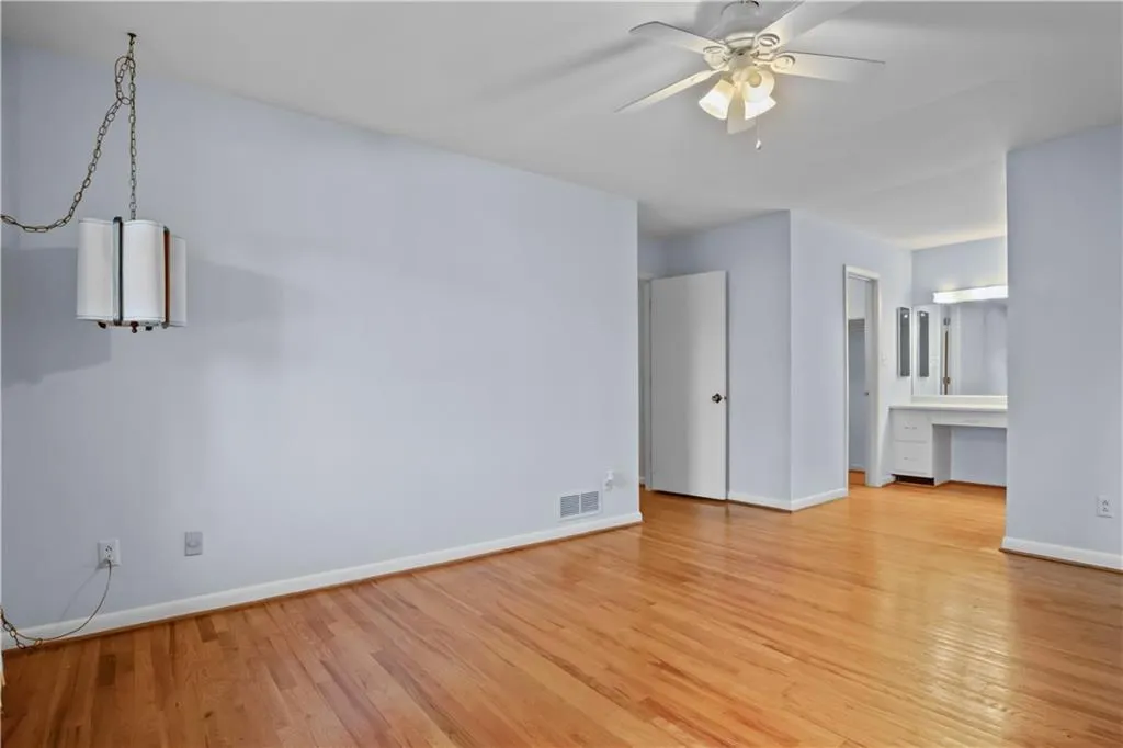 Spare room with ceiling fan, light hardwood / wood-style flooring, and built in desk Spare room with ceiling fan, light hardwood / wood-style flooring, and built in desk