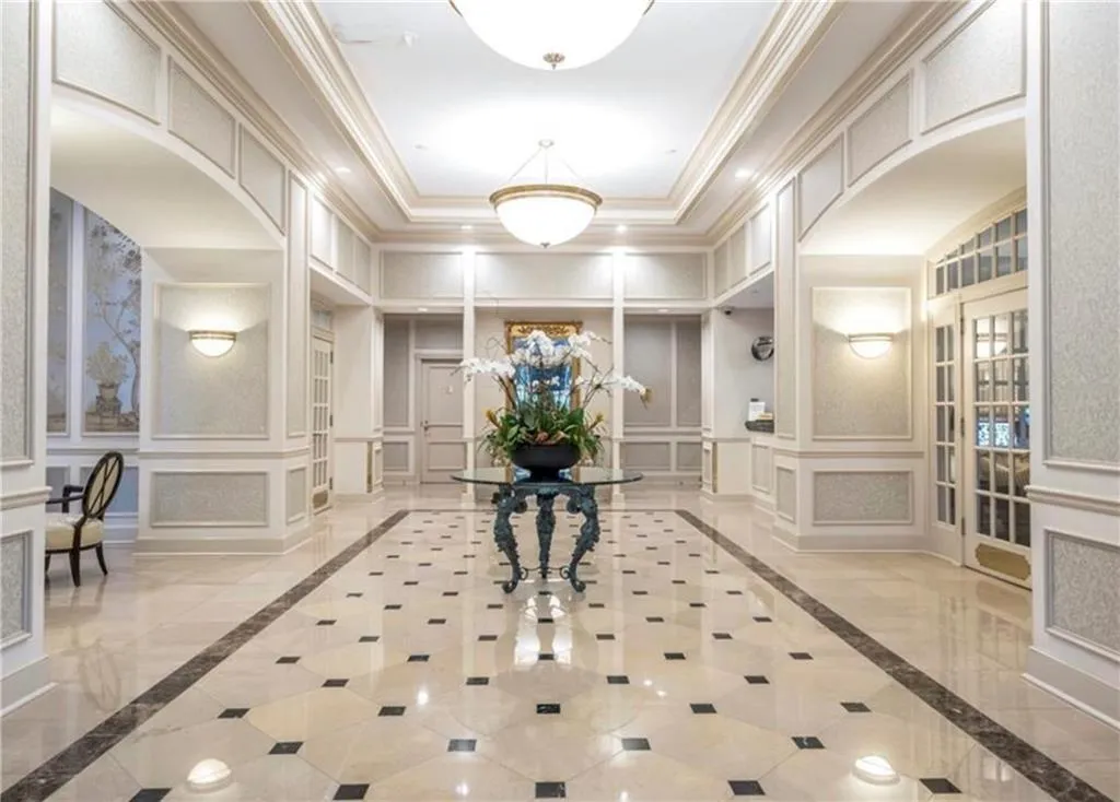 Hall featuring crown molding and a raised ceiling