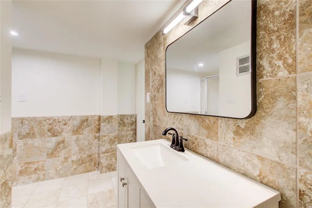 Terrace level bathroom has a new vanity, mirror & lighting.