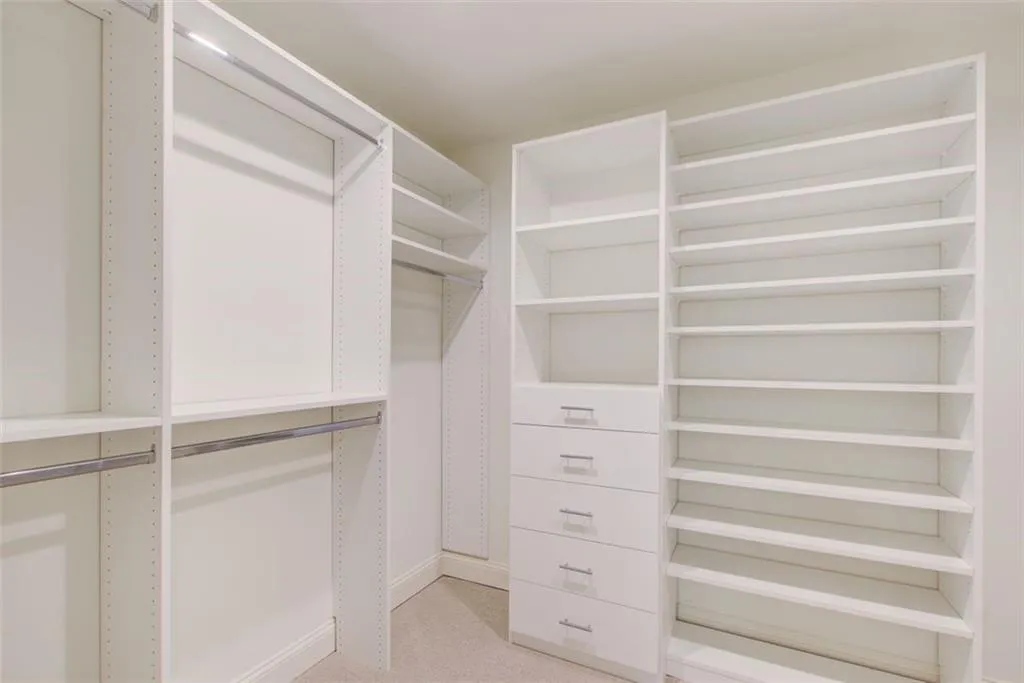 Generously sized custom walk-in closet in the primary suite
