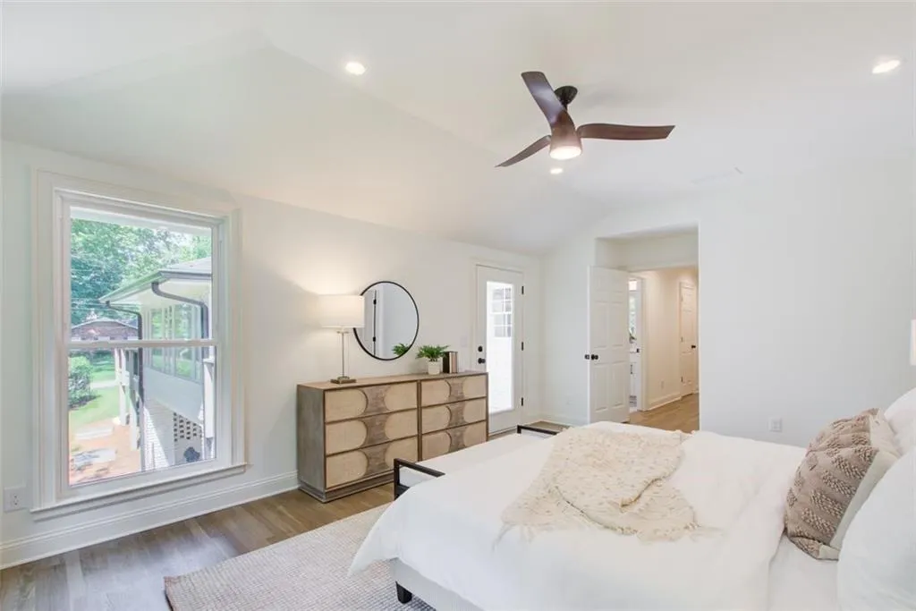 Primary suite has recessed lighting & door to deck