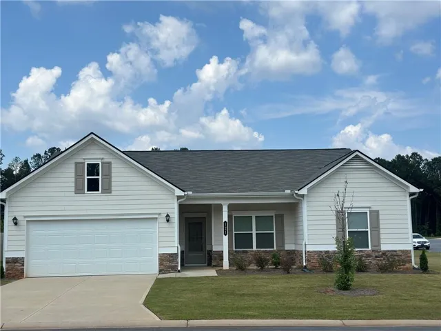 Light-colored siding exterior with stone accenting
