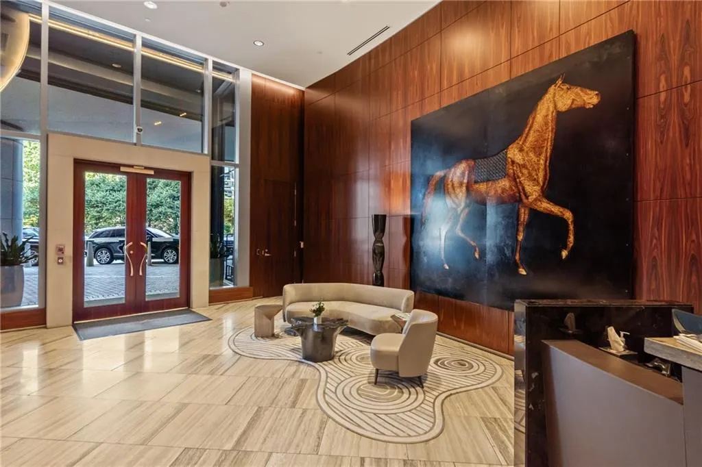 Community lobby with wood walls and a towering ceiling