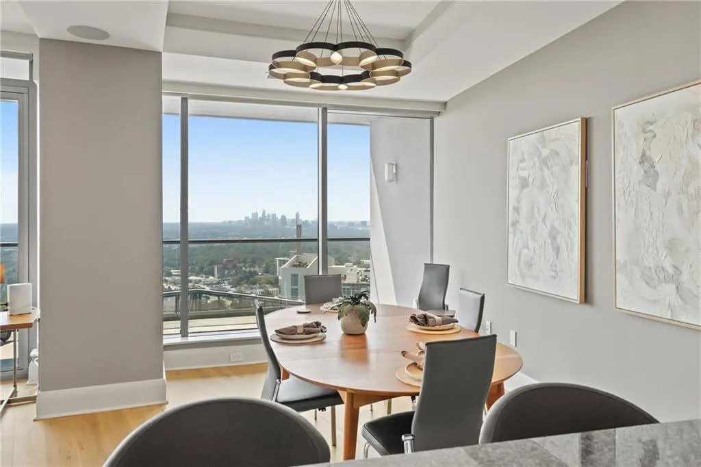 Dining room with a city view, light wood-style flooring, and a chandelier