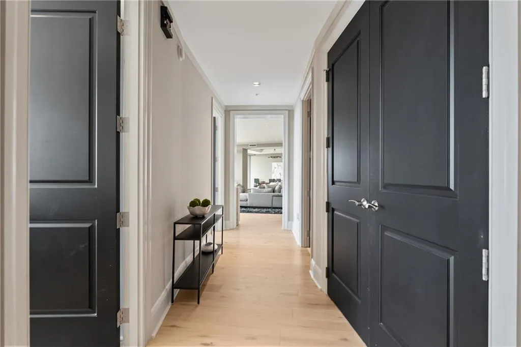 Corridor featuring light wood-style flooring and baseboards