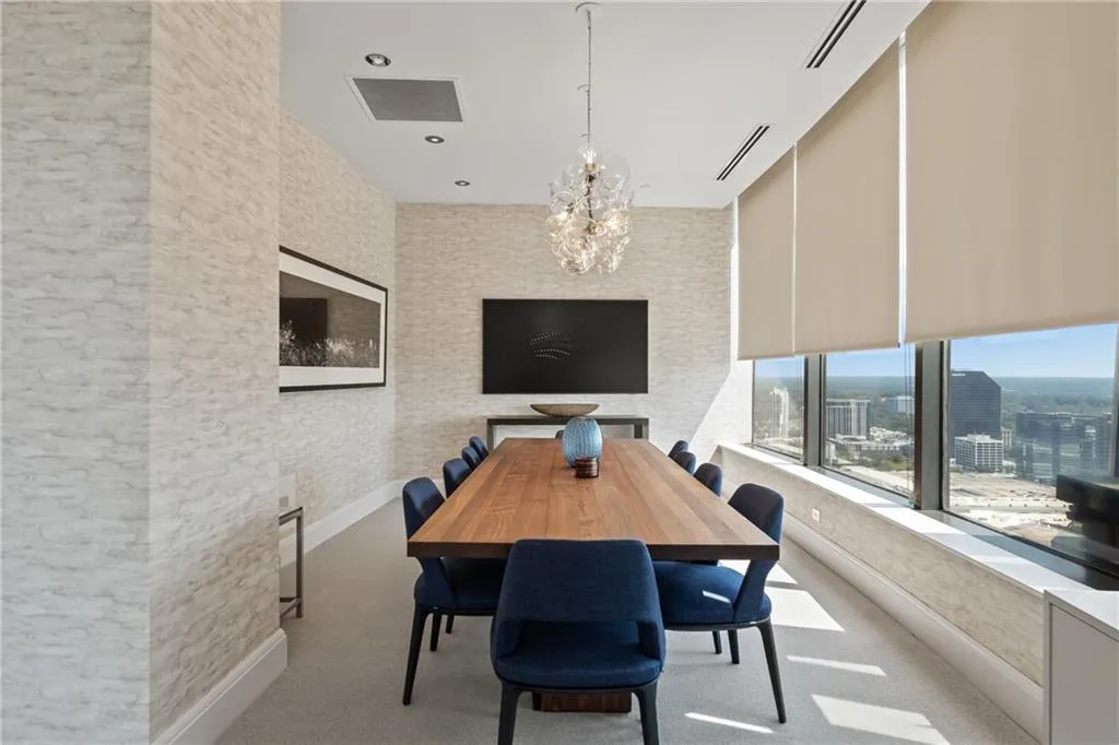 Dining area featuring a chandelier, light carpet, and recessed lighting