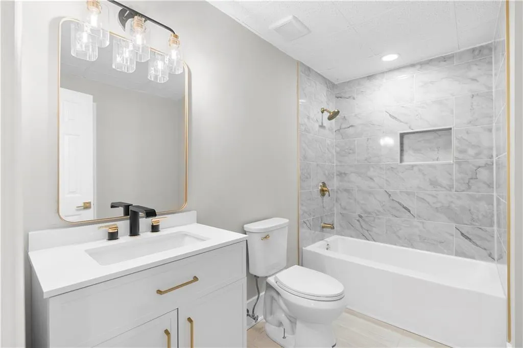 Bathroom featuring vanity, bathing tub / shower combination, and recessed lighting