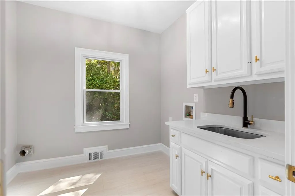 Laundry area featuring cabinet space and hookup for a washing machine