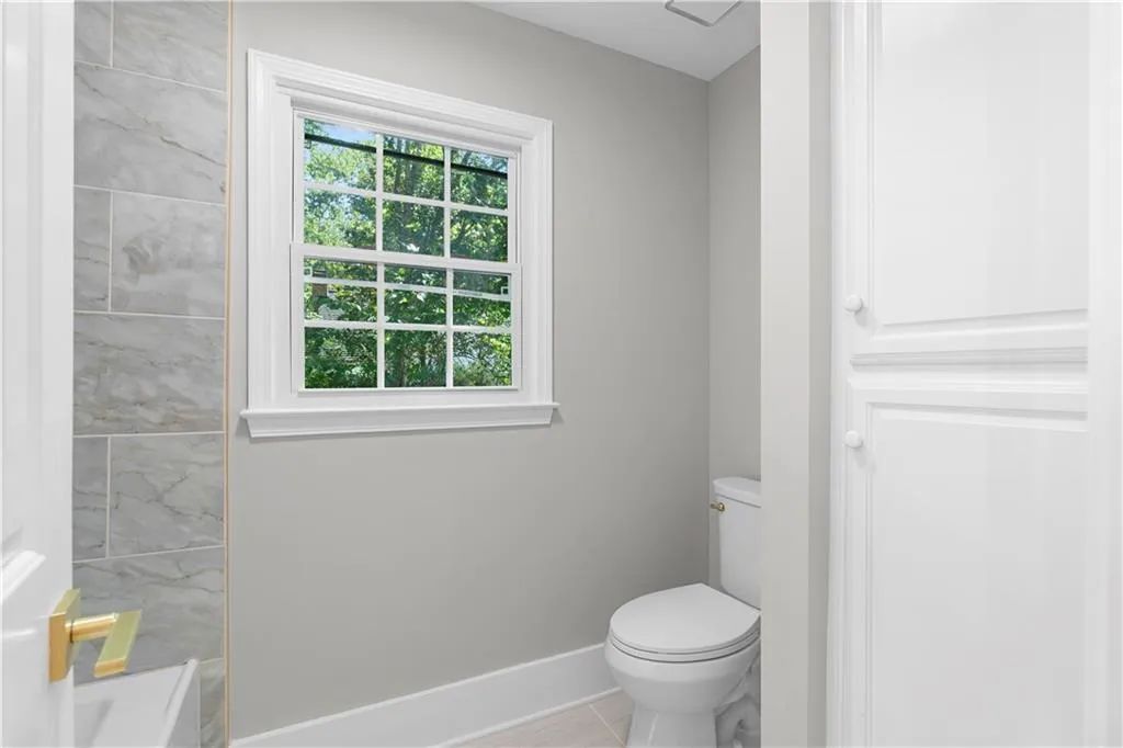 Bathroom with toilet and baseboards