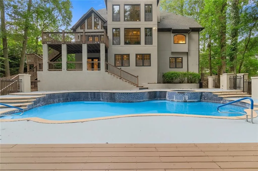 View of swimming pool with stairway, a deck, a patio, and a pool with connected hot tub