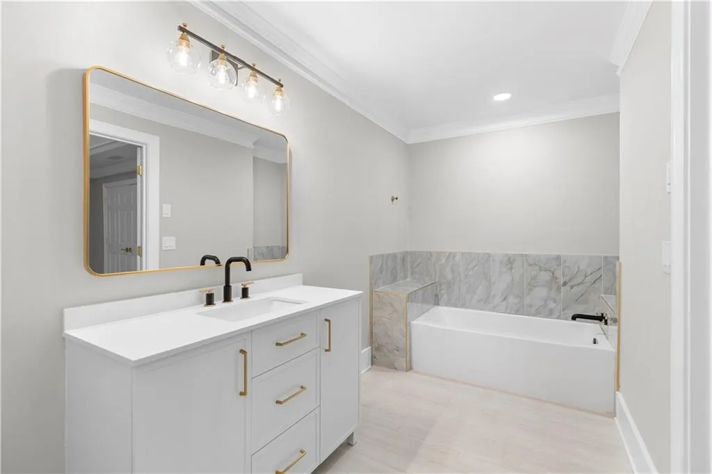 Full bath with vanity, a bath, crown molding, and recessed lighting