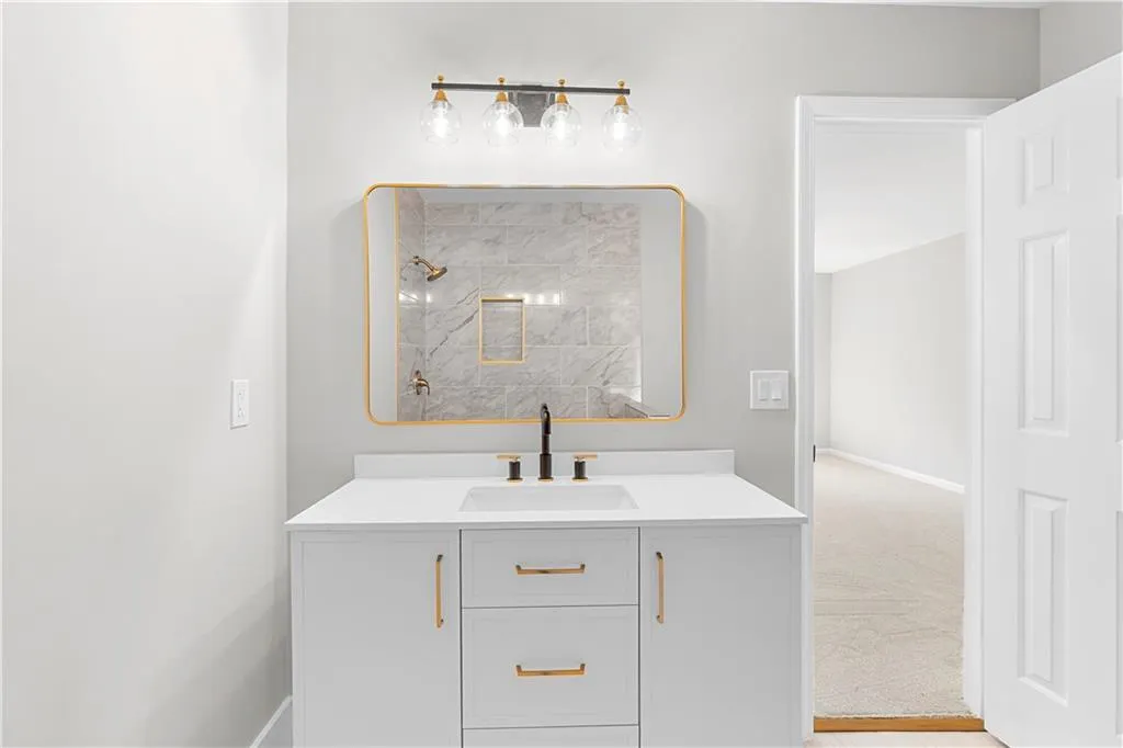 Full bath with vanity and a tile shower