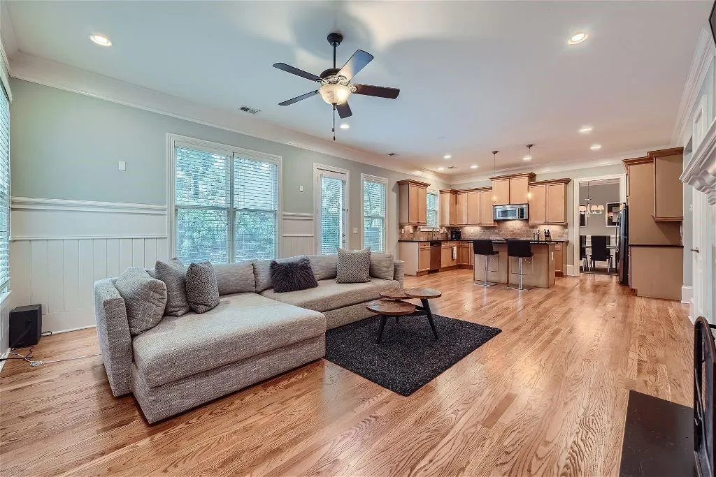 Living room featuring ceiling fan, light hardwood / wood-style floors, and ornamental molding