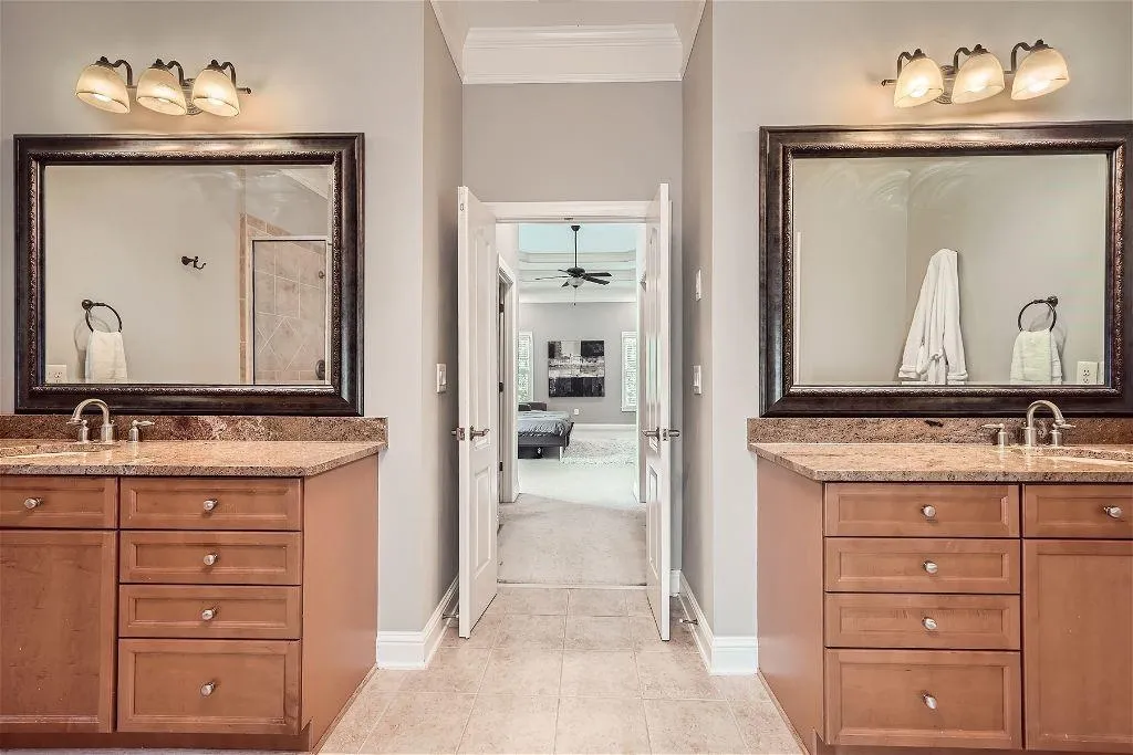 Bathroom with tile floors, crown molding, vanity, and ceiling fan