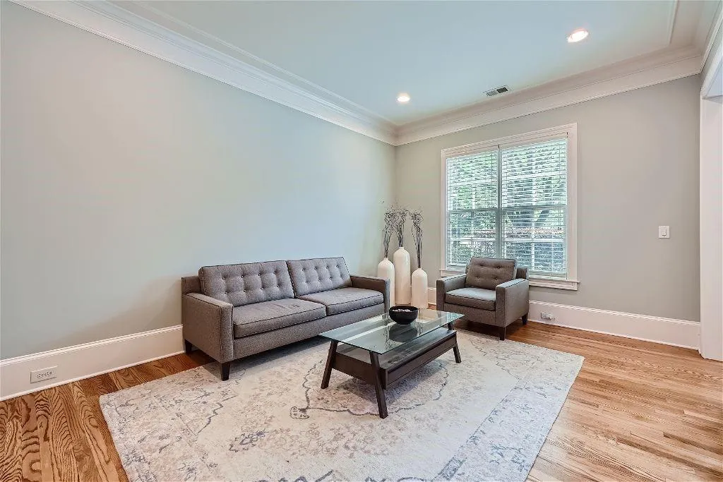 Living room with crown molding and hardwood / wood-style flooring