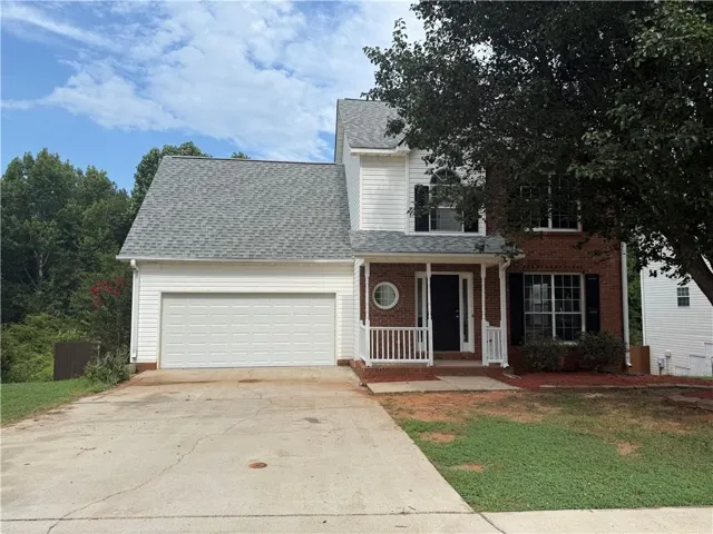 Brick and siding exterior with a covered porch