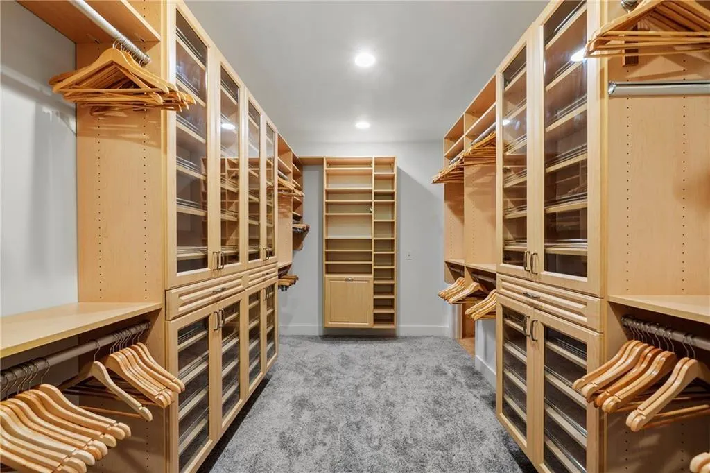 Spacious closet with light carpet