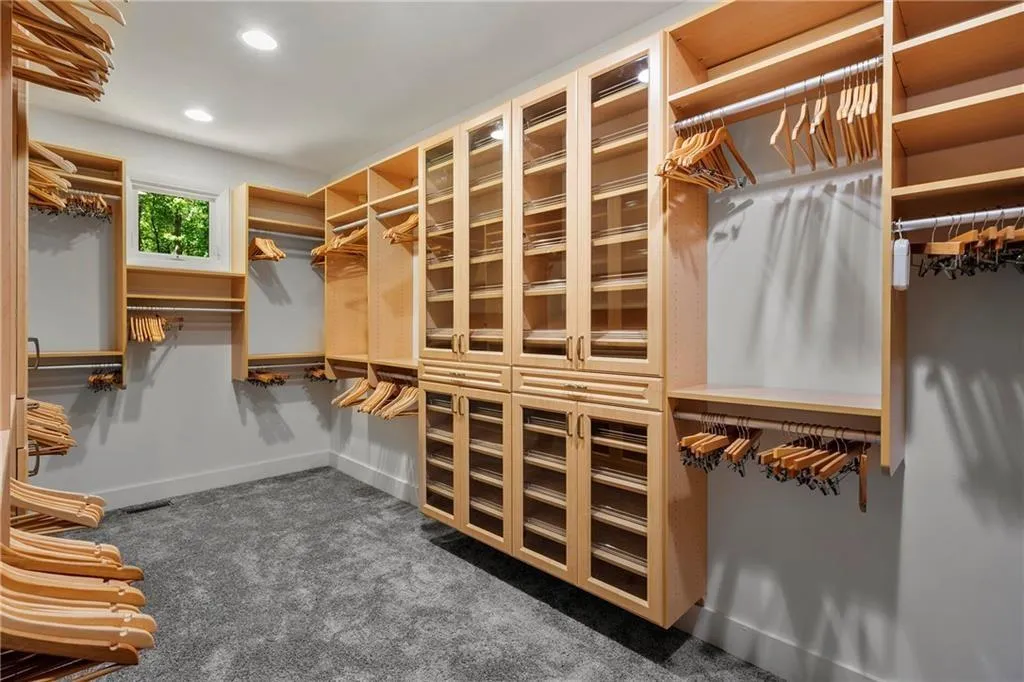 Spacious closet with dark colored carpet
