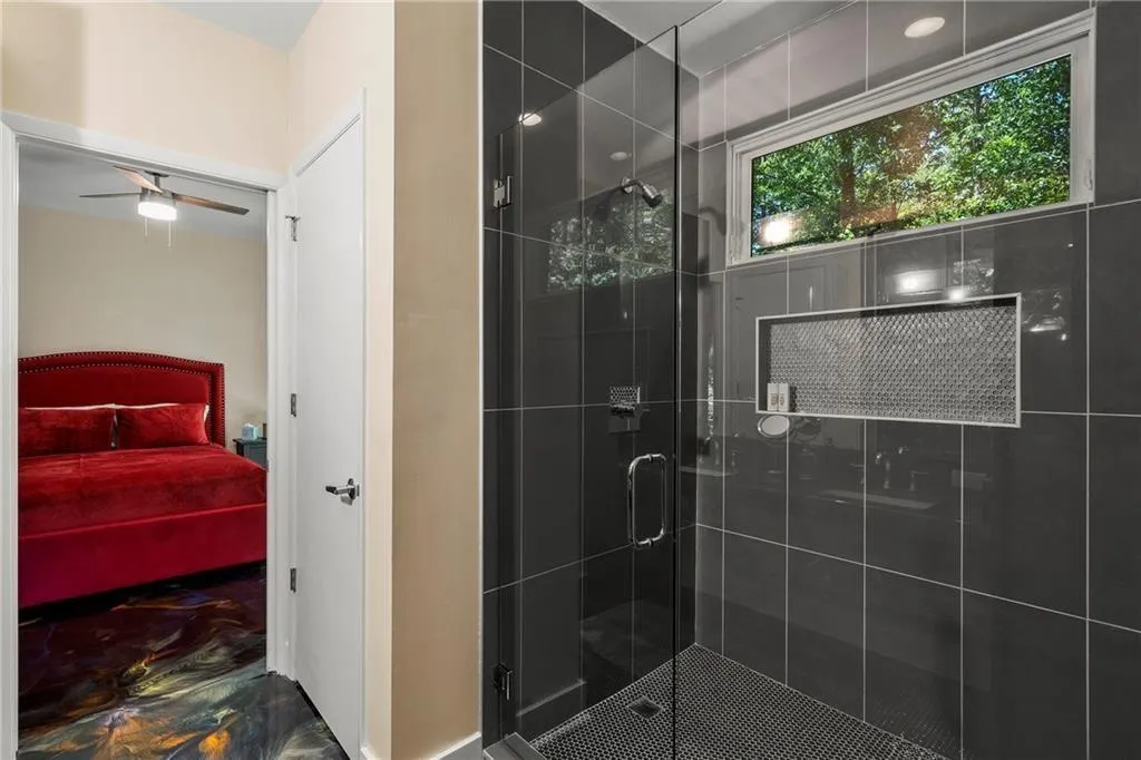 Full bath with a stall shower, ensuite bathroom, and ceiling fan