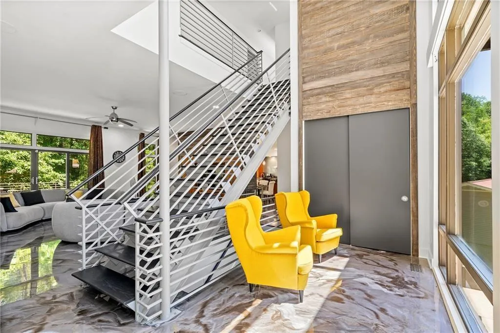 Stairway with marble tiled floors and a ceiling fan