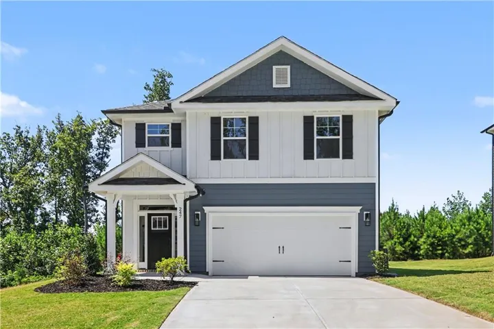 Contemporary two-story residence with a covered entry, attached two-car garage, and a concrete driveway