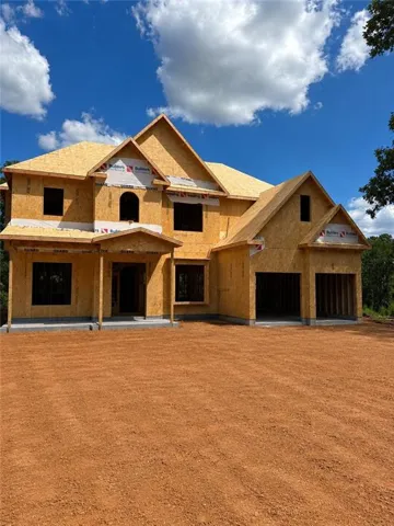 New construction property featuring a prominent main entrance, multiple gables, and an integrated two-car garage