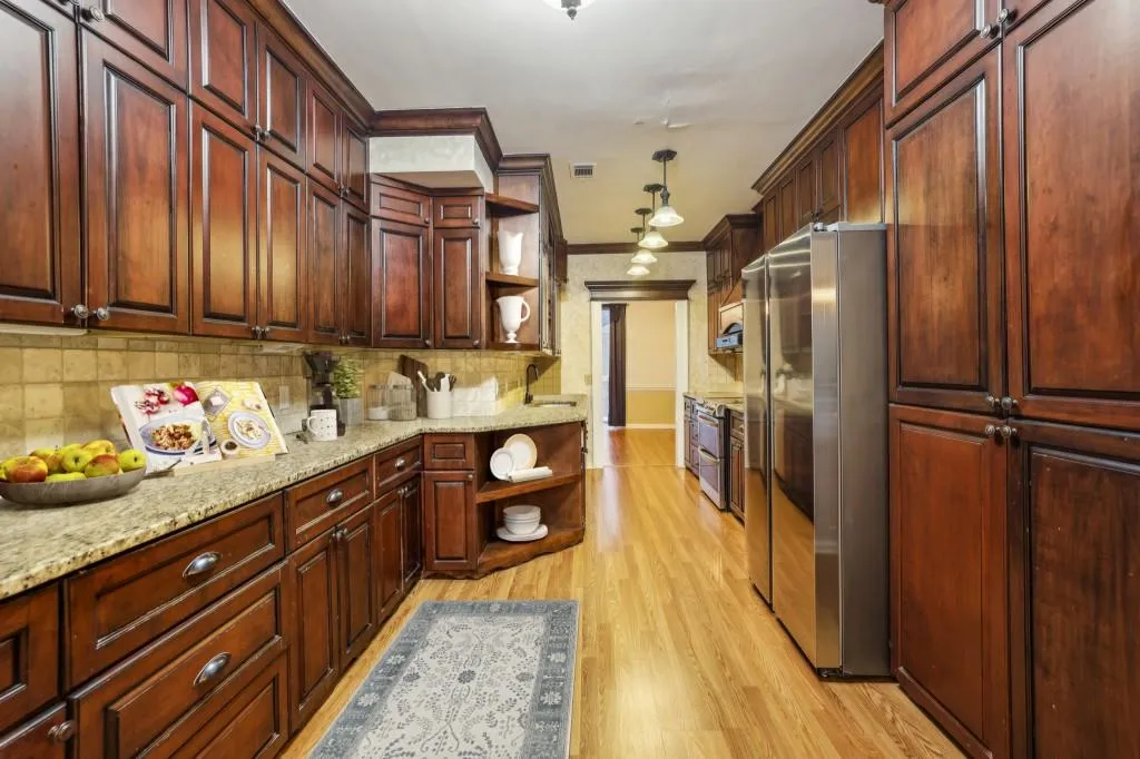 Spacious Kitchen With Granite Counters, Stone Backsplash, & Stainless Steel Appliances
