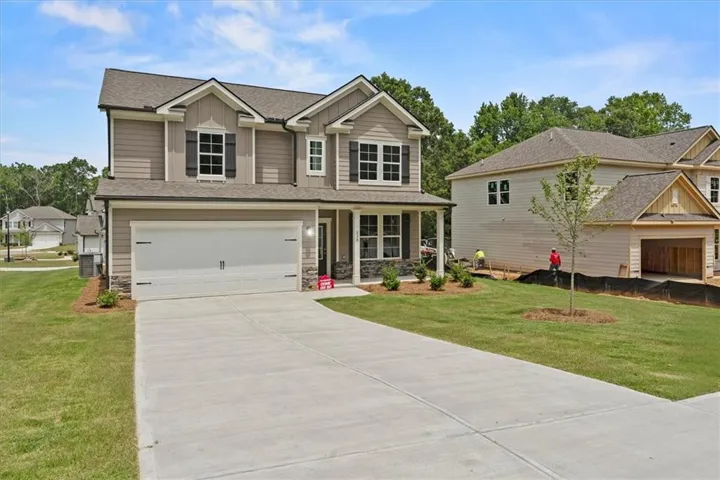 Two-story residence featuring a two-car garage with a concrete driveway