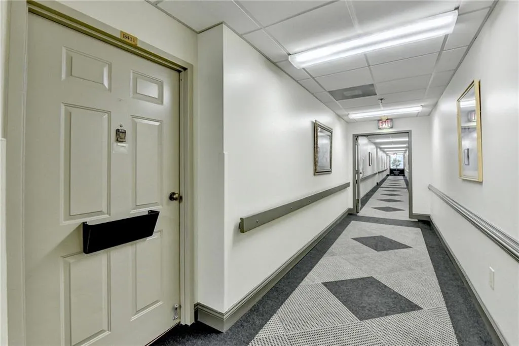 Hallway with a paneled ceiling
